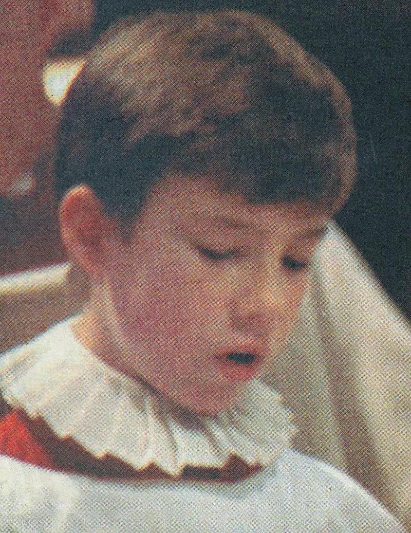A young chorister in cassock and ruff